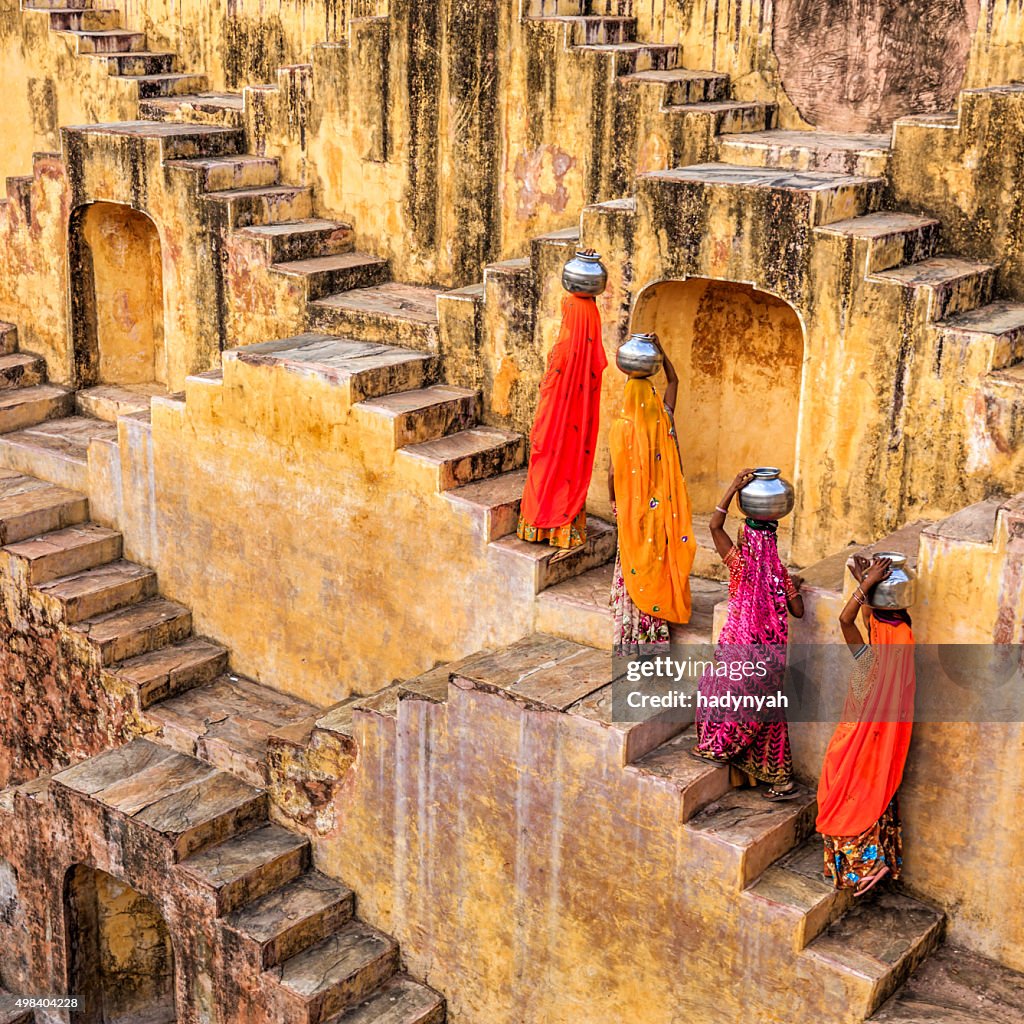 Indian women carrying water from stepwell near Jaipur