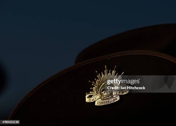 Seen is the iconic 'Rising Sun' hat badge worn by an Australian soldier from the Royal Australian Regiment during a commemorative parade at Lavarack...