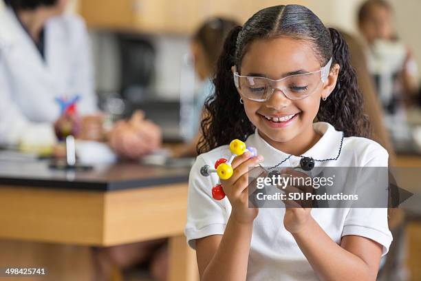 elementary school student learning science with atom model - chemistry model stock pictures, royalty-free photos & images