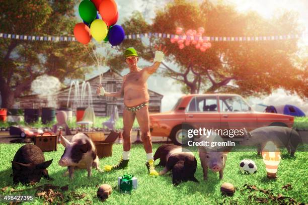 eccentric funny old clown protecting his bizarre farm home - kitsch stockfoto's en -beelden