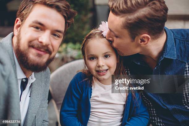 gay parents with daughter - surrogacy stock pictures, royalty-free photos & images