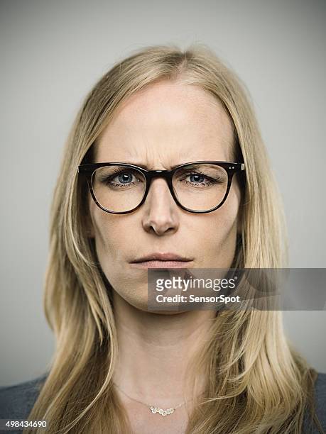 portrait of a young german woman looking at camera - young face serious at camera stockfoto's en -beelden