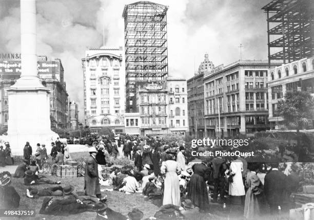 As fires rage in the background, in the wake of a massive eathquake, the newly homeless gather at Union Square, San Francisco, California, April 18,...