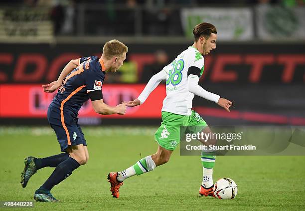 Ismail Azzaoui of Wolfsburg is challenged by Janek Sternberg of Bremen during the Bundesliga match between VfL Wolfsburg and Werder Bremen at...