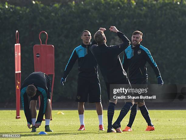 Aaron Ramsey and Kieran Gibbs of Arseanl share a joke with team-mate Per Mertesacker during a training session at London Colney on November 23, 2015...