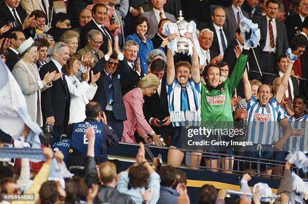 Coventry City captain Brian Kilcline lifts the trophy after the 1987 FA Cup Final between Coventry City and Tottenham Hotspur at Wembley Stadium on...