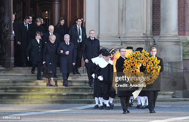 German guards of honor carry a coffin as German President Joachim Gauck and Helmut Schmidt's daughter Susanne Schmidt walk behind during the funeral...