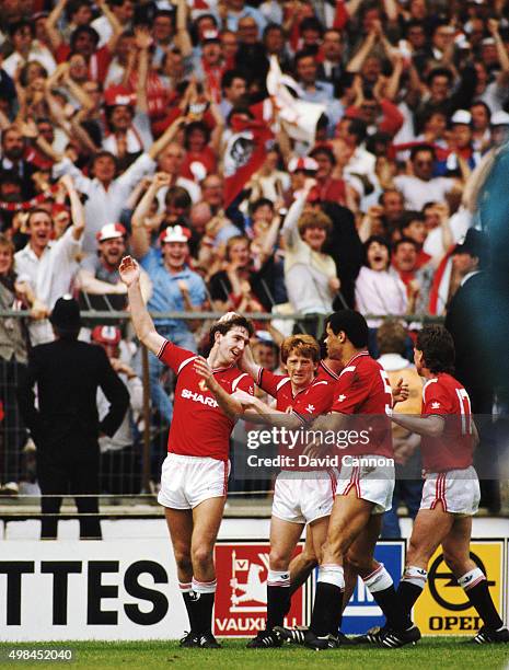 Goalscorer Norman Whiteside is congratulated by team mates Gordon Strachan, Paul McGrath and Mike Duxbury after scoring the winning goal during the...