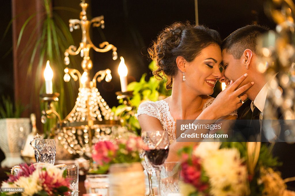 Newlywed couple sharing romantic moments at dinner