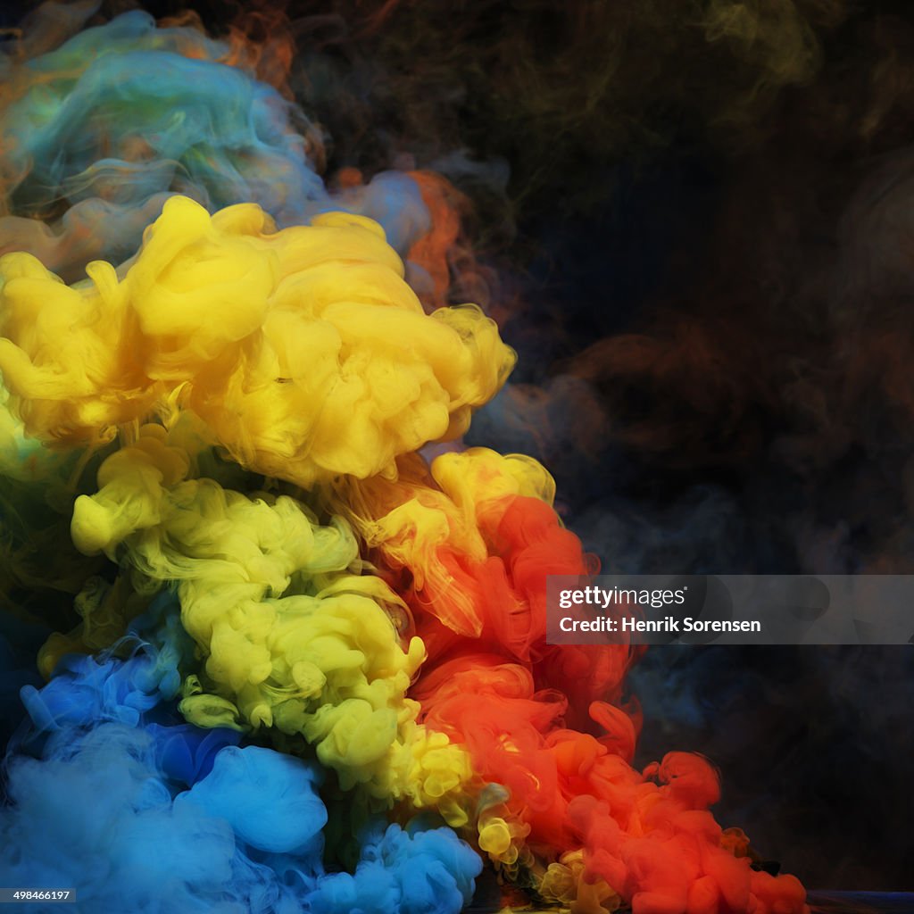 Coloured smoke mixing in dark room