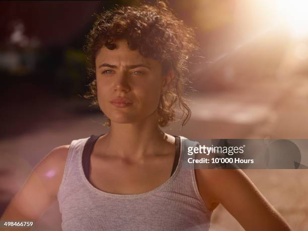 a woman preparing for a run on a sunny evening - passion sport stock pictures, royalty-free photos & images