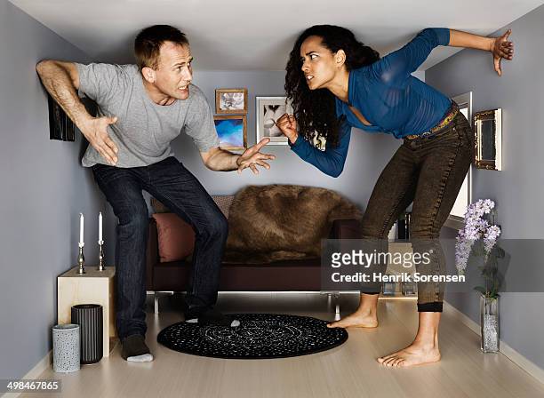 couple in smallscale living room - couple trapped stock pictures, royalty-free photos & images