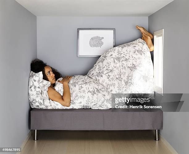 young woman in small  bed room - claustrophobia stock pictures, royalty-free photos & images