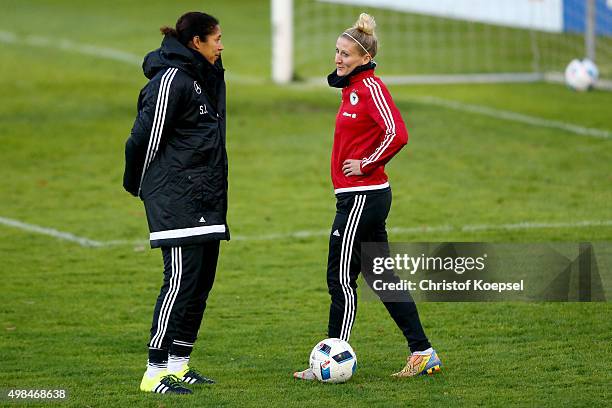 Head coach Steffi Jones speaks to Anja Mittag of Germany during a training session ahead of the friendly match between Women's Germany Team and...