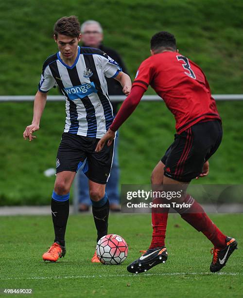 Lewis McNall of Newcastle dribbles the ball whilst Josh Ezewele of West Bromwich looks to challenge during the U21 Premier League Match between...