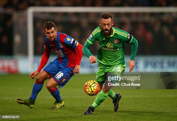 Steven Fletcher of Sunderland is pursued by James McArthur of Crystal Palace during the Barclays Premier League match between Crystal Palace and...