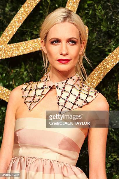 British model Poppy Delevigne poses for pictures on the red carpet upon arrival to attend the British Fashion Awards 2015 in London on November 23,...