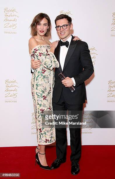 Alexa Chung and Erdem Moralioglu pose in the Winners Room at the British Fashion Awards 2015 at London Coliseum on November 23, 2015 in London,...