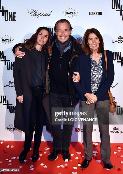 French humorist Michel Leeb poses with his wife Beatrice and his daughter Elsa as he arrives to attend the 'Un + Une' Paris Premiere on November 23,...