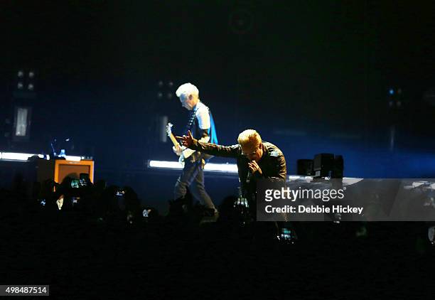 Musicians Adam Clayton and Bono of U2 perform onstage at 3 Arena on November 23, 2015 in Dublin, Ireland.