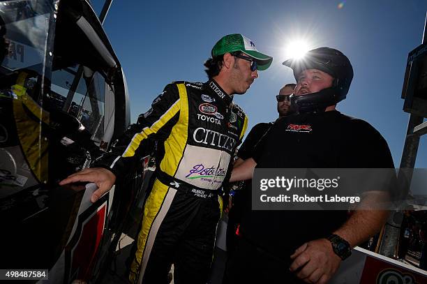 Ruben Pardo, driver of the BYB Chevrolet, stands on the grid during qualifying for the NASCAR Camping World Truck Series Lucas Oil 150 at Phoenix...