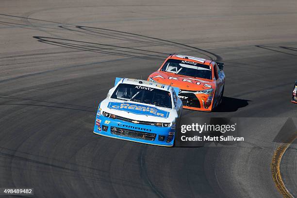 Dylan Kwasniewski, driver of the MagicCreeper.comVroom Brands Chevrolet, races with Daniel Suarez, driver of the ARRIS Toyota, during the NASCAR...