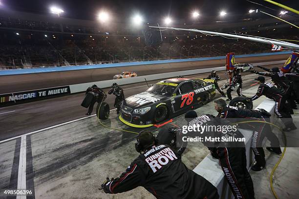 Martin Truex Jr., driver of the Furniture Row/Visser Precision Chevrolet, pits during the NASCAR Sprint Cup Series Quicken Loans Race for Heroes 500...