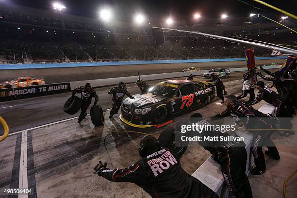 Martin Truex Jr., driver of the Furniture Row/Visser Precision Chevrolet, pits during the NASCAR Sprint Cup Series Quicken Loans Race for Heroes 500...