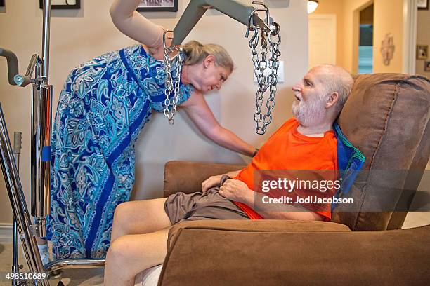 in home care: woman is helping her ill husband - pulley stock pictures, royalty-free photos & images