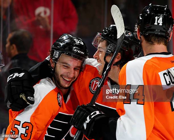 Shayne Gostisbehere of the Philadelphia Flyers is congratulated by Taylor Leier after Gostisbehere scored the game winner in overtime against the...