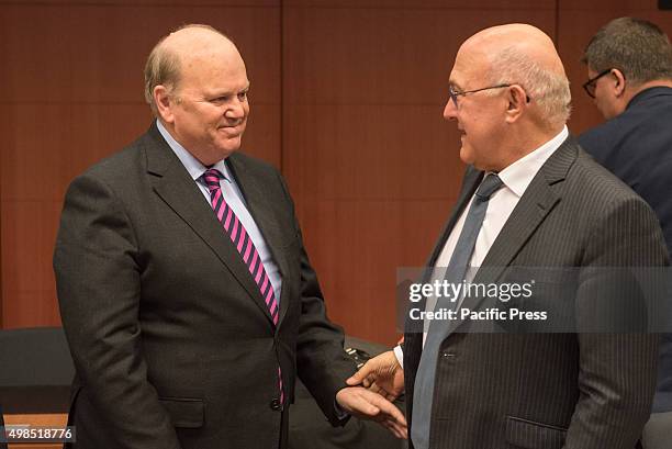 Irish Finance Minister Michael Noonan and French Finance Minister Michel Sapin speak to each other at the start of the Eurogroup meeting. The...