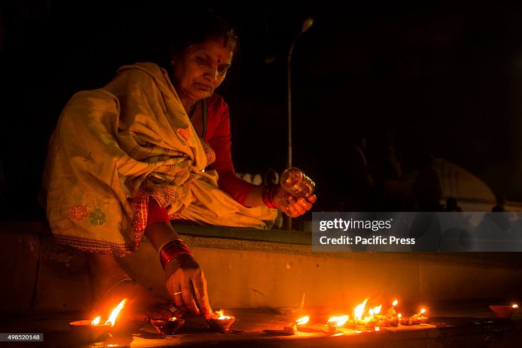 A woman lit candles during the Dev Uthani, also known as...