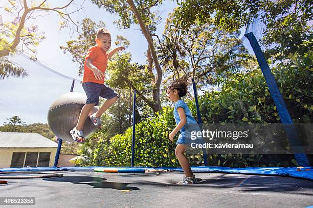 bouncing on the trampoline - children only stock pictures, royalty-free photos & images