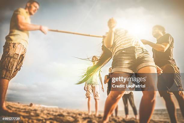 limbo game on the beach - limbo stockfoto's en -beelden