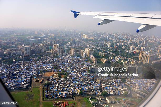 Aerial view of Mumbai city and Dharavi slums seen from inside an airplane.