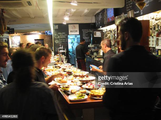 Counter of a bar with a variety of tapas and pinchos, both traditional and more elaborate tapas are a small sample of the renowned Basque cuisine,...