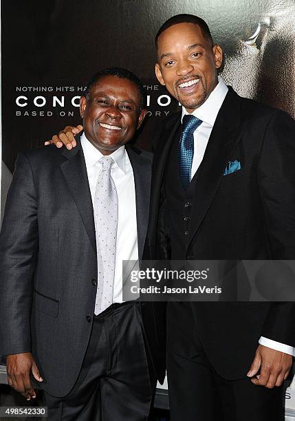 Dr. Bennet Omalu and actor Will Smith attend a screening of "Concussion" at Regency Village Theatre on November 23, 2015 in Westwood, California.