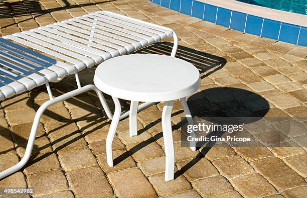 deck chair and a backless chair by the pool - sedia stock pictures, royalty-free photos & images