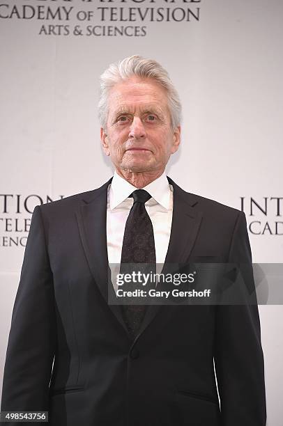 Presenter, actor Michael Douglas poses for pictures during the 43rd International Emmy Awards press room reception on November 23, 2015 in New York...