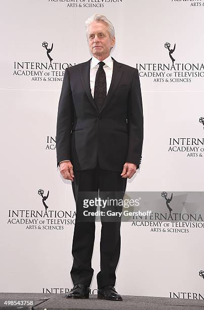 Presenter, actor Michael Douglas poses for pictures during the 43rd International Emmy Awards press room reception on November 23, 2015 in New York...