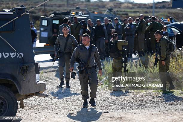 Israeli security forces gather at the spot where a Palestinian man was shot by Israeli forces after reportedly ramming a vehicle into a number of...