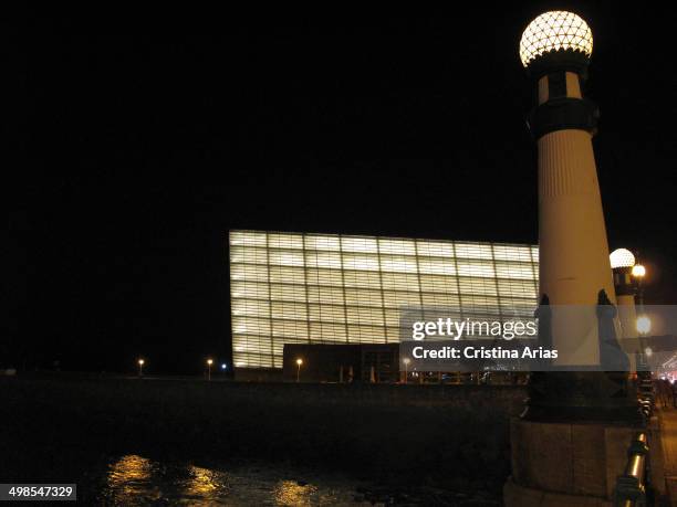 Zurriola Bridge over the River Urumea, with its singular lampposts, and the Kursaal Congress Palace illuminated at night, San Sebastian , Guipuzcoa,...