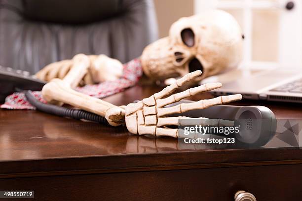 skeleton of man who died while waiting "on hold".  telephone. - patience office stock pictures, royalty-free photos & images