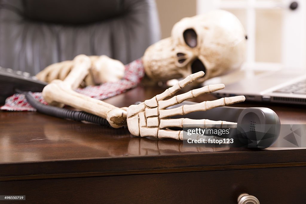 Skeleton of man who died while waiting "on hold". Telephone.