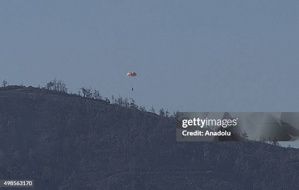 Russian pilot parachutes out of a warplane which went down in Syria's northwestern Turkmen town of Bayirbucak near Turkeys border on November 24,...