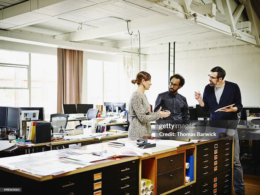 Female architect leading discussion in office