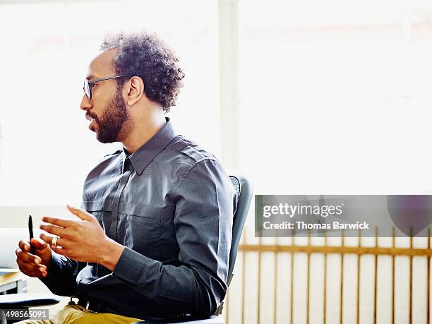 businessman in discussion in office - real people office stock pictures, royalty-free photos & images