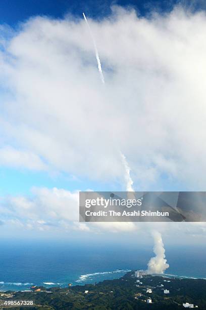 In this aerial image, the H-2A Launch Vehicle No.29 of the Japan Aerospace Exploration Agency and Mitsubishi Heavy Industries leaves a contrail after...