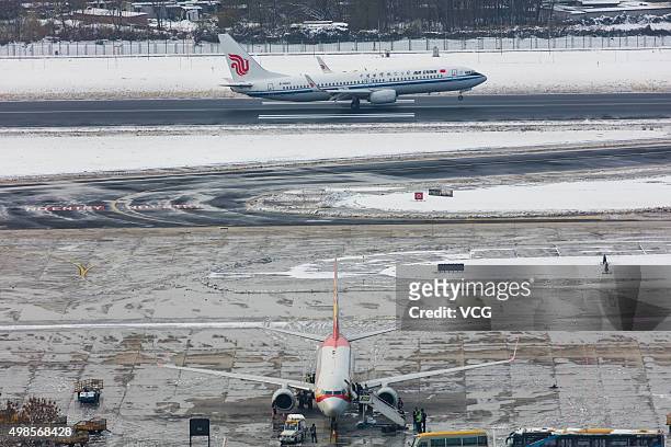 Aircraft are seen at the Beijing Capital International Airport on November 23, 2015 in Beijing, China. Workers cleared the snow at the Beijing...
