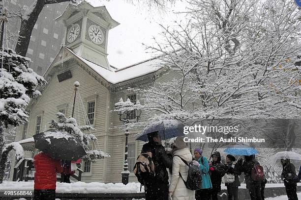 Tourists from Southeast Asia visits snow-covered Sapporo Clock Tower on November 24, 2015 in Sapporo, Hokkaido, Japan. Due to the snowfall, at least...